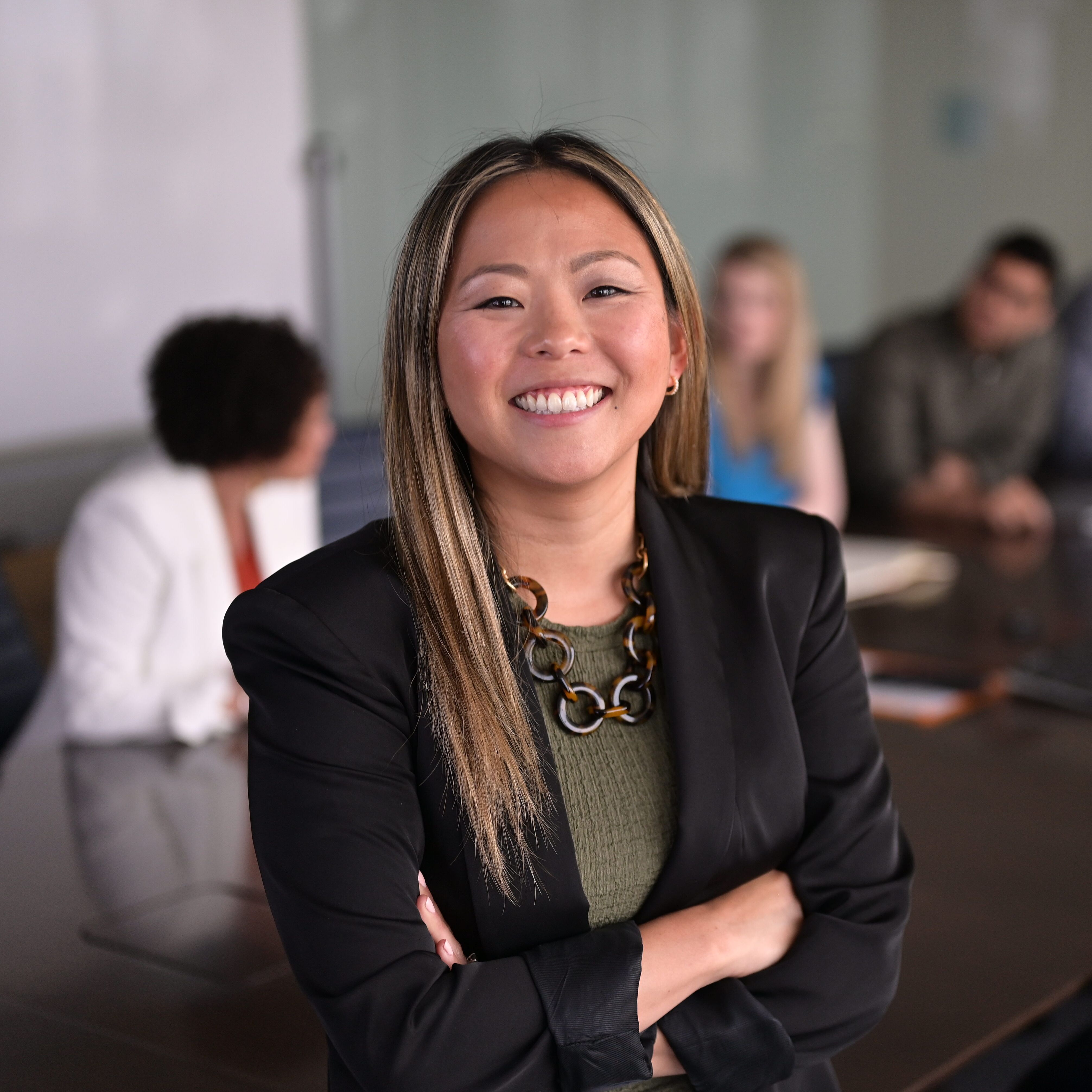 Woman standing in front of a board room table